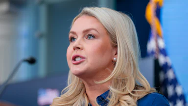 Press Secretary Karoline Leavitt speaks at a podium during a White House press briefing