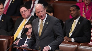 Representative Dan Bishop speaks at a podium on the House floor