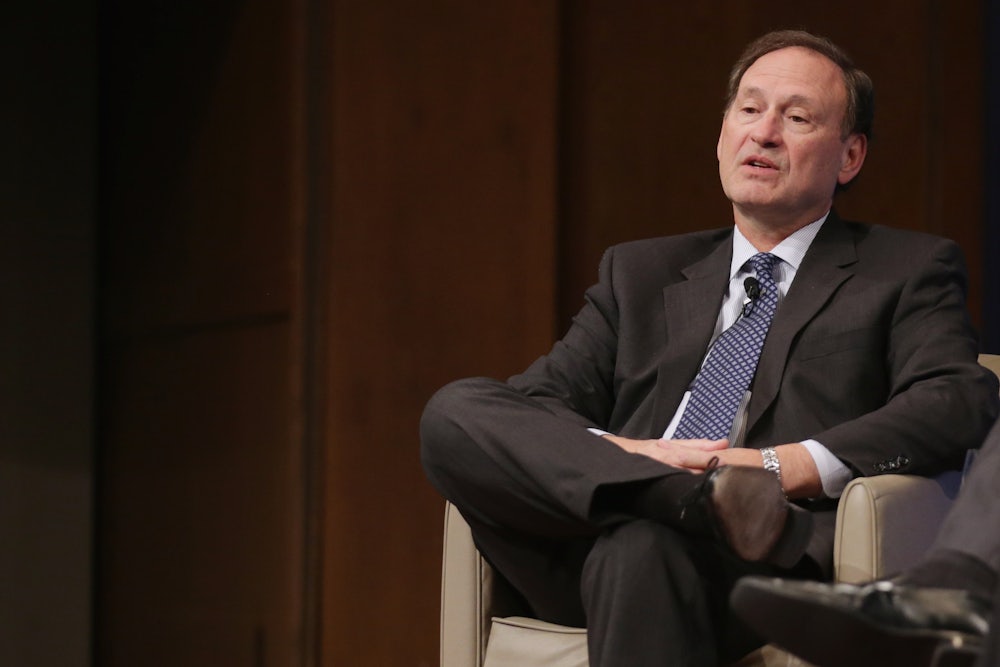Supreme Court Justice Samuel Alito reclines in a chair.