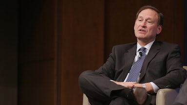 Supreme Court Justice Samuel Alito reclines in a chair.