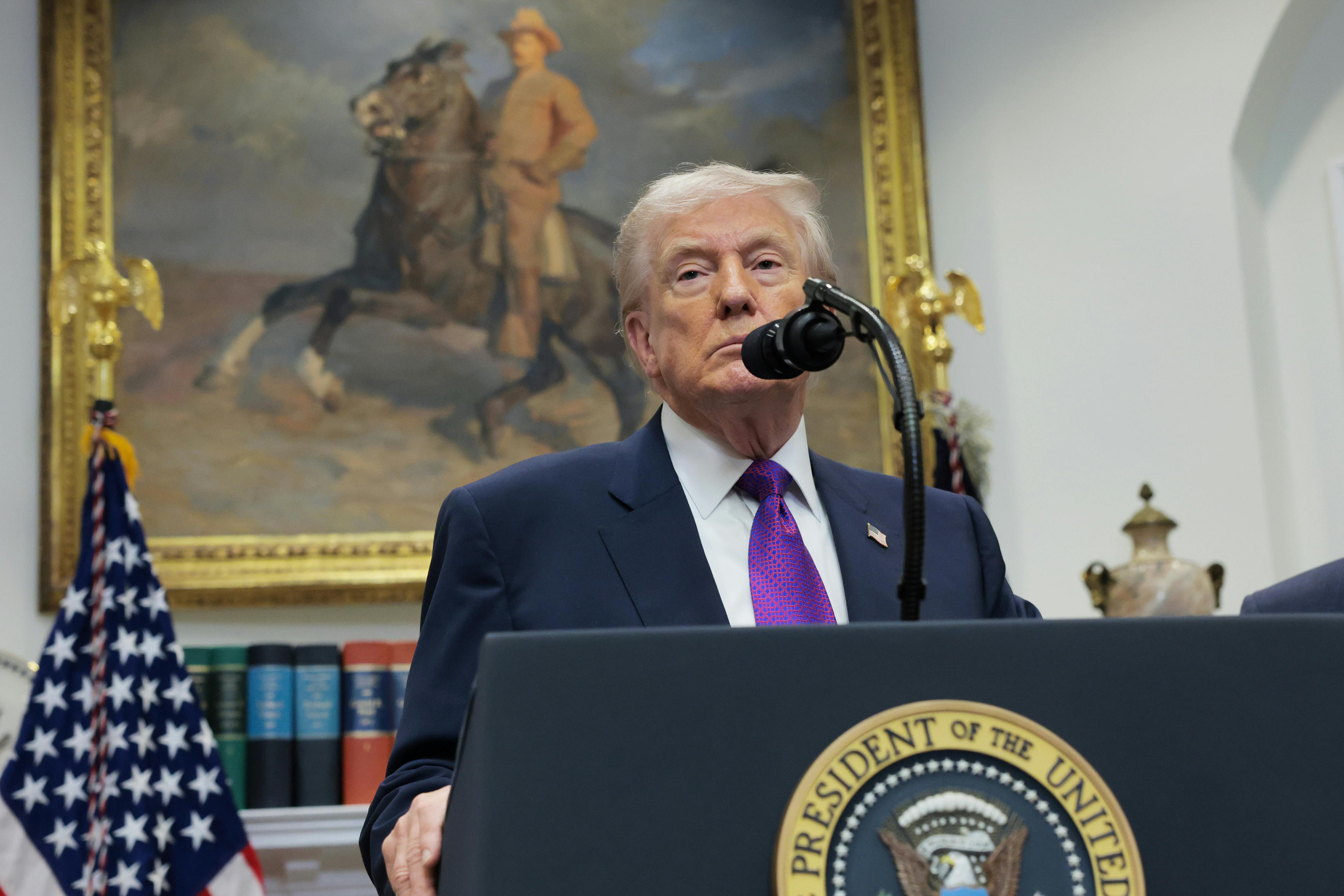 Donald Trump speaks at a podium in the White House/