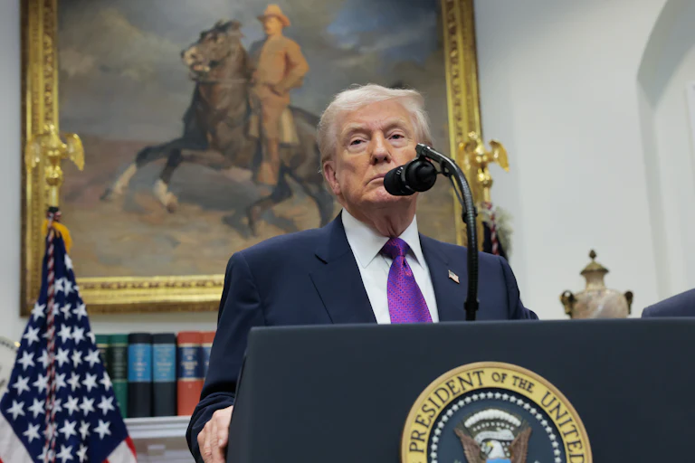 Donald Trump speaks at a podium in the White House/