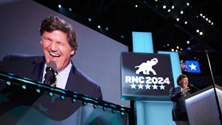 Tucker Carlson arrives to speak on stage on the fourth day of the 2024 Republican National Convention.