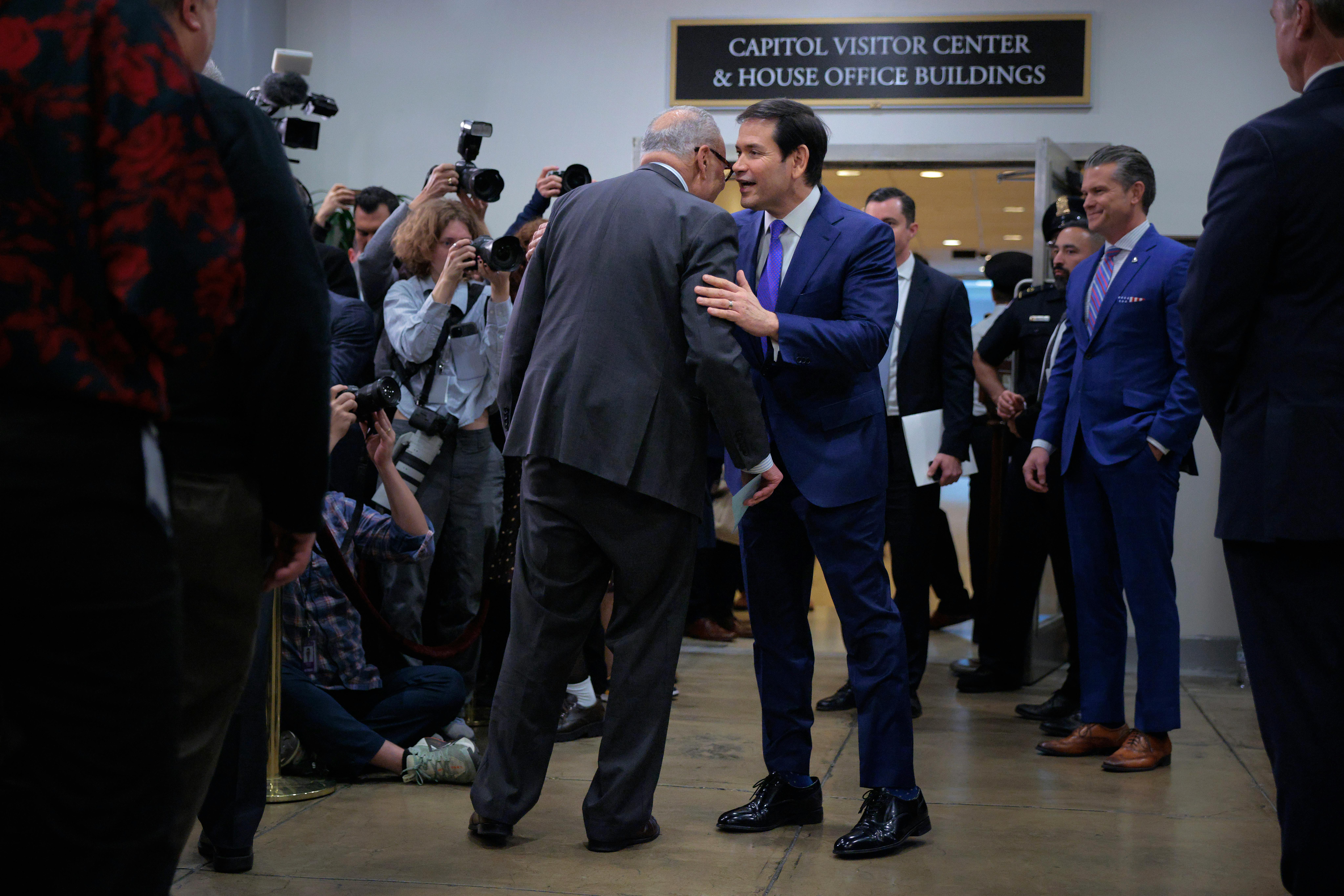 Senate Minority Leader Chuck Schumer and Secretary of State Marco Rubio speak while surrounded by reporters
