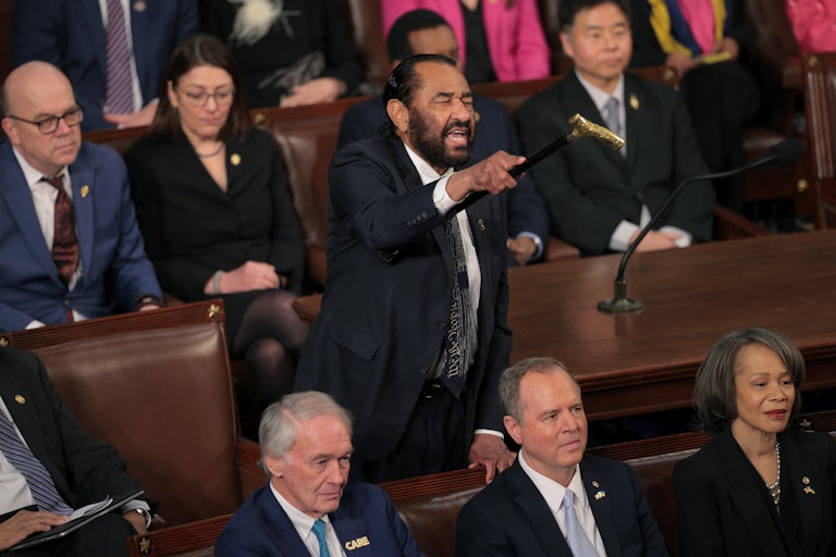 Representative Al Green stands and points while shouting during Donald Trump’s address to a joint session of Congress