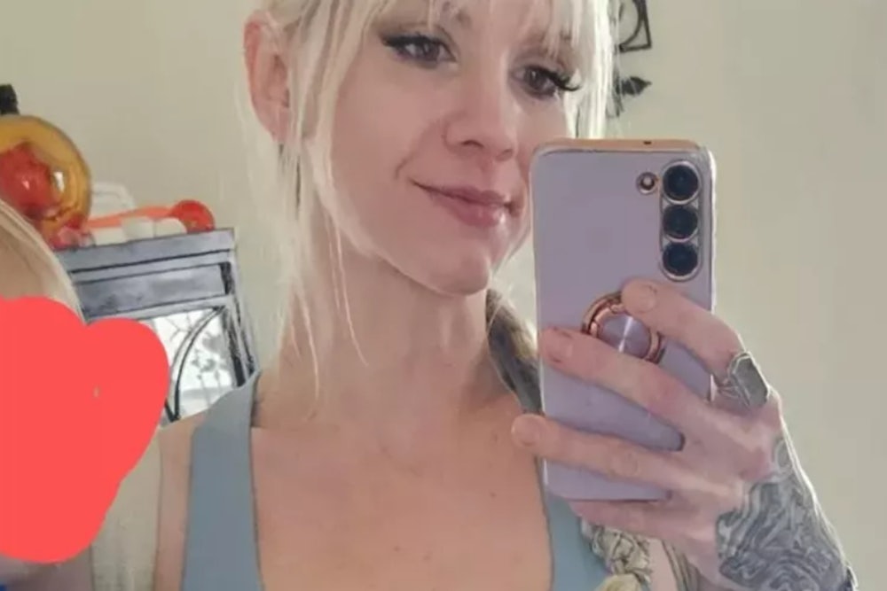 Shiloh Hendrix, as pictured on her GiveSendGo page, holds a cell phone in front of her face.