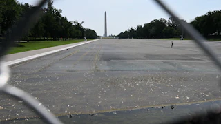 The Reflecting Pool, seen through a chain-link fence