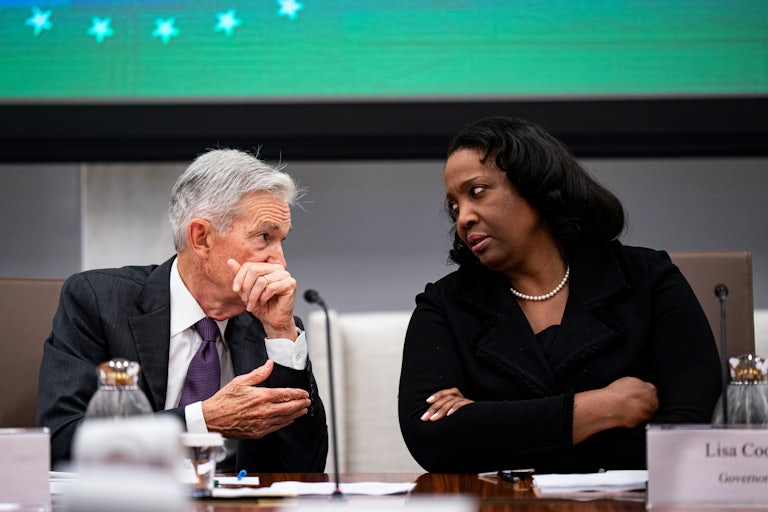 Lisa Cook speaks to Jerome Powell in a Federal Reserve meeting.