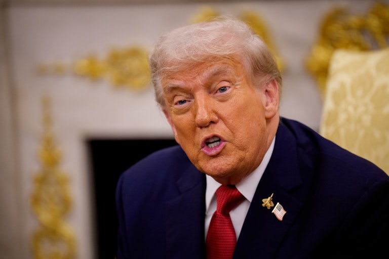 Donald Trump speaks while sitting in the Oval Office
