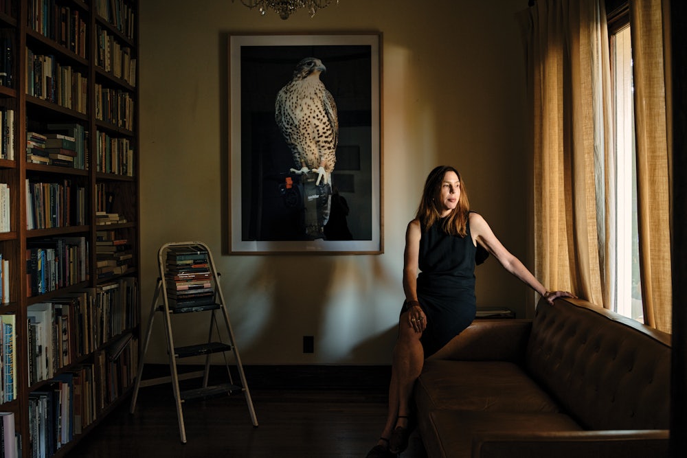 Author Rachel Kushner rests on her sofa at home.