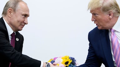 Donald Trump shakes hands with Russian President Vladimir Putin during the G20 summit in 2019.