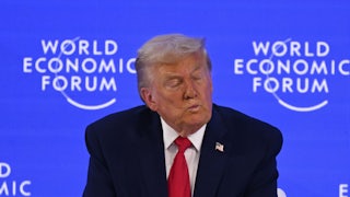 Donald Trump puckers his lips and closes his eyes while sitting on stage at the World Economic Forum in Davos, Switzerland
