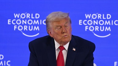Donald Trump puckers his lips and closes his eyes while sitting on stage at the World Economic Forum in Davos, Switzerland