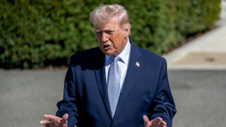 Donald Trump gestures and speaks outside the White House