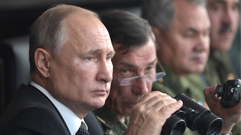 Vladimir Putin watches a military exercise in 2019