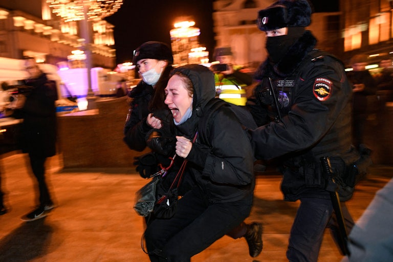 Police officers detain a demonstrator during a protest against Russia's invasion of Ukraine in Moscow.