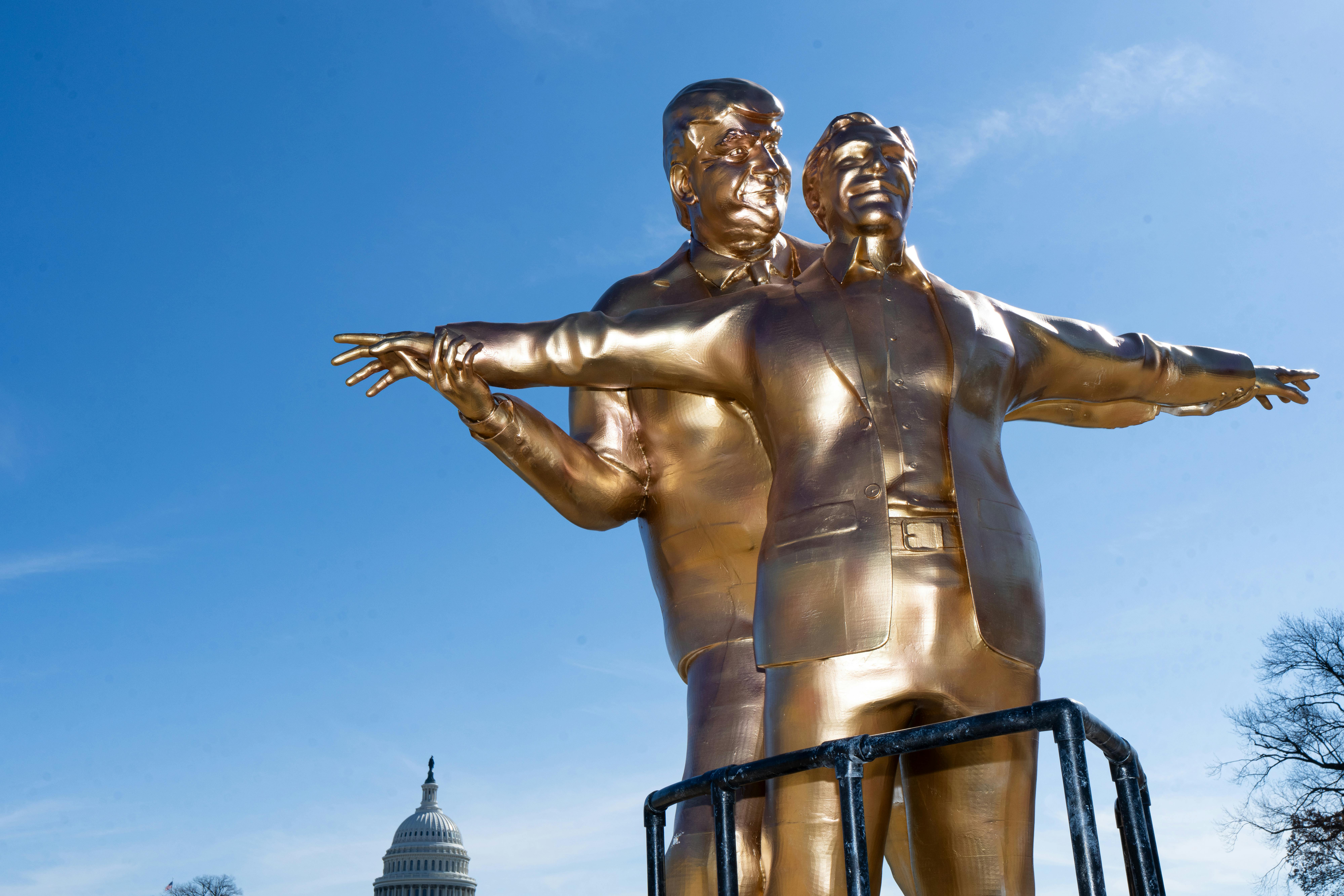 A bronze Donald Trump statue holds up Jeffrey Epstein's arms, as if Jack and Rose in Titanic (respectively).