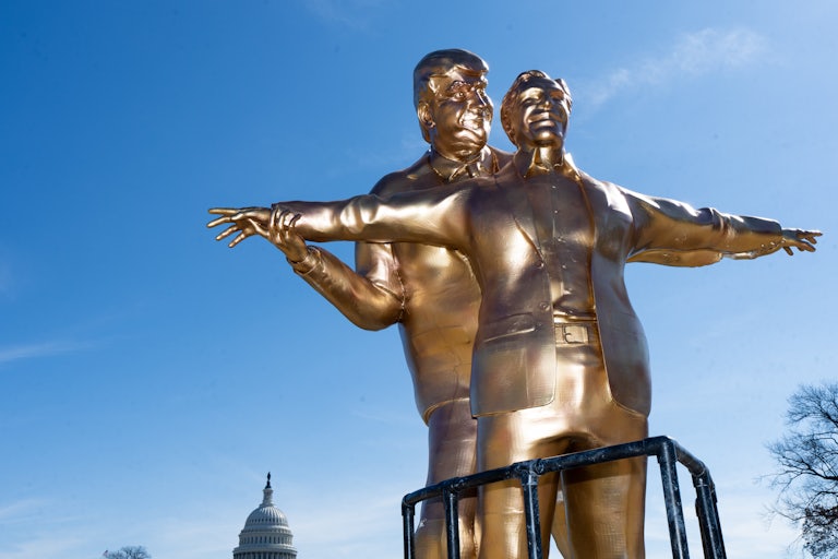 A bronze Donald Trump statue holds up Jeffrey Epstein's arms, as if Jack and Rose in Titanic (respectively).