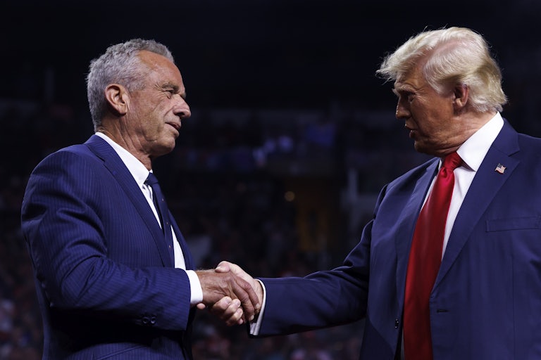 Donald Trump and Robert F. Kennedy Jr. shake hands on stage at a Trump rally