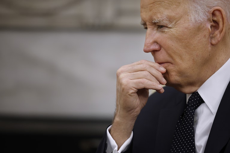 Joe Biden touches his face