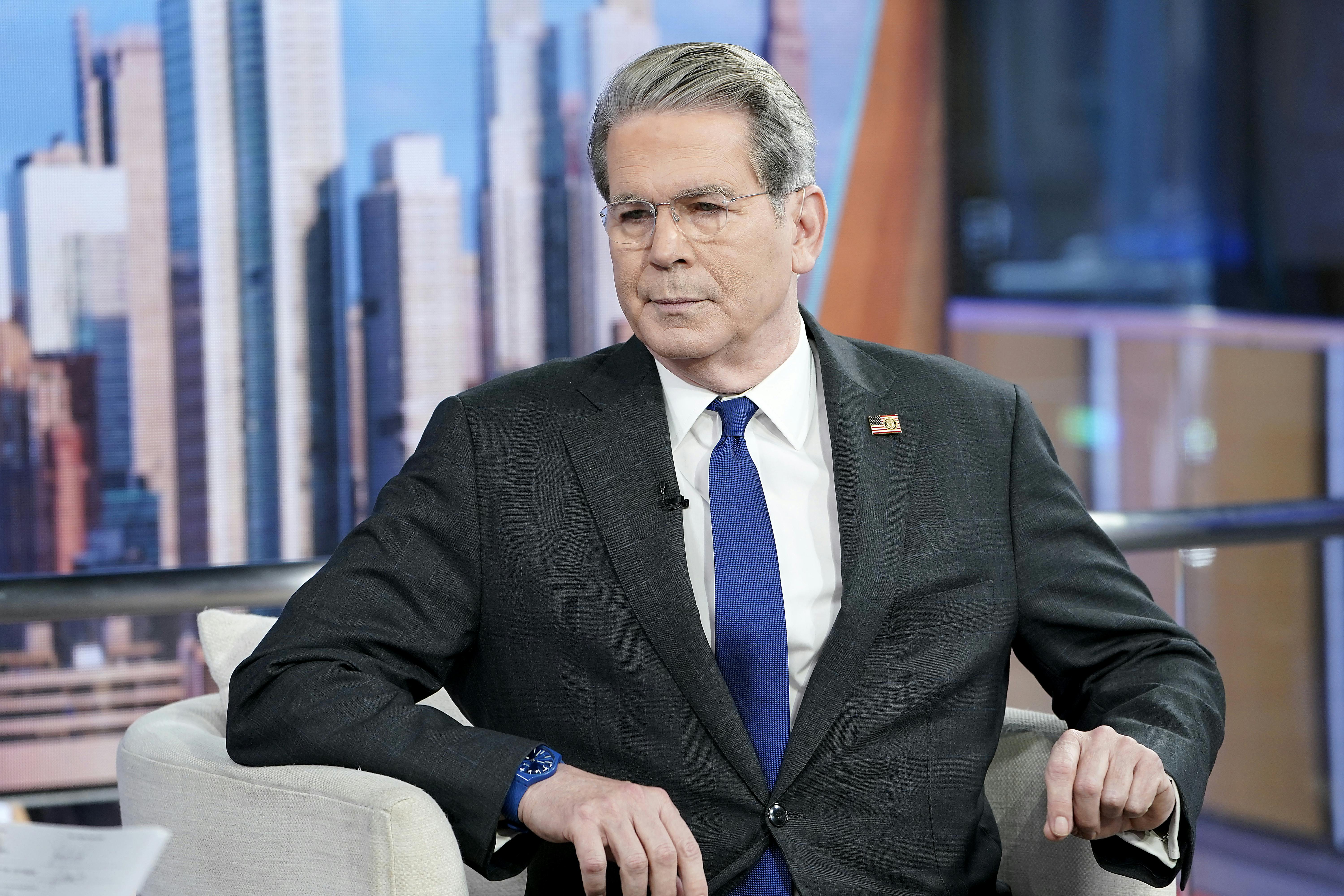 Treasury Secretary Scott Bessent sits in a chair at an interview. 