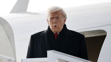 Donald Trump puckers his lips as he exits Air Force One