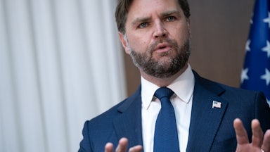 JD Vance speaking, puts his hands up as if in defense