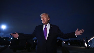 Donald Trump holds his arms out to the side while speaking