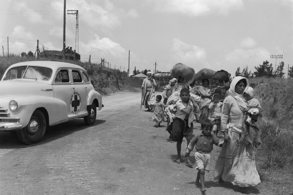 The International Red Cross assists Arab civilians moving from the Jewish sector into Arab territory in Jerusalem in 1948