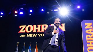 Zohran Mamdani on stage celebrating his election win.