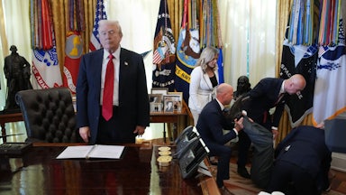 Donald Trump stands at his desk in the Oval Office while people help Gordon Findlay, a Novo Nordisk executive who collapsed