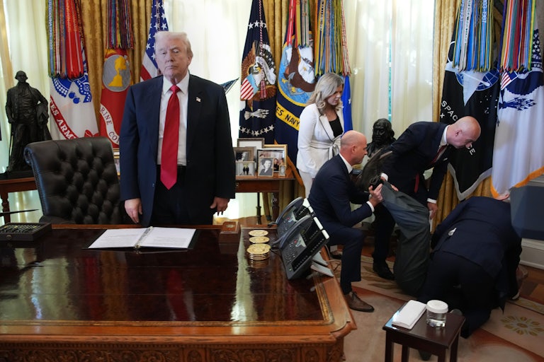 Donald Trump stands at his desk in the Oval Office while people help Gordon Findlay, a Novo Nordisk executive who collapsed