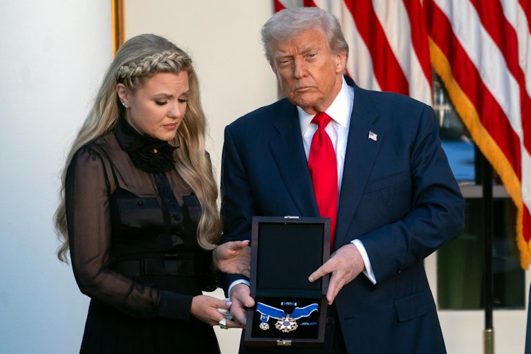 Donald Trump stands in the White House Rose Garden and presents a Presidential Medal of Freedom to Charlie Kirk's widow Erika