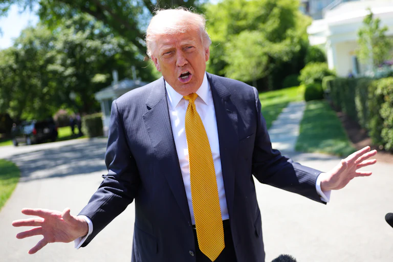 Trump holds his arms out while talking
