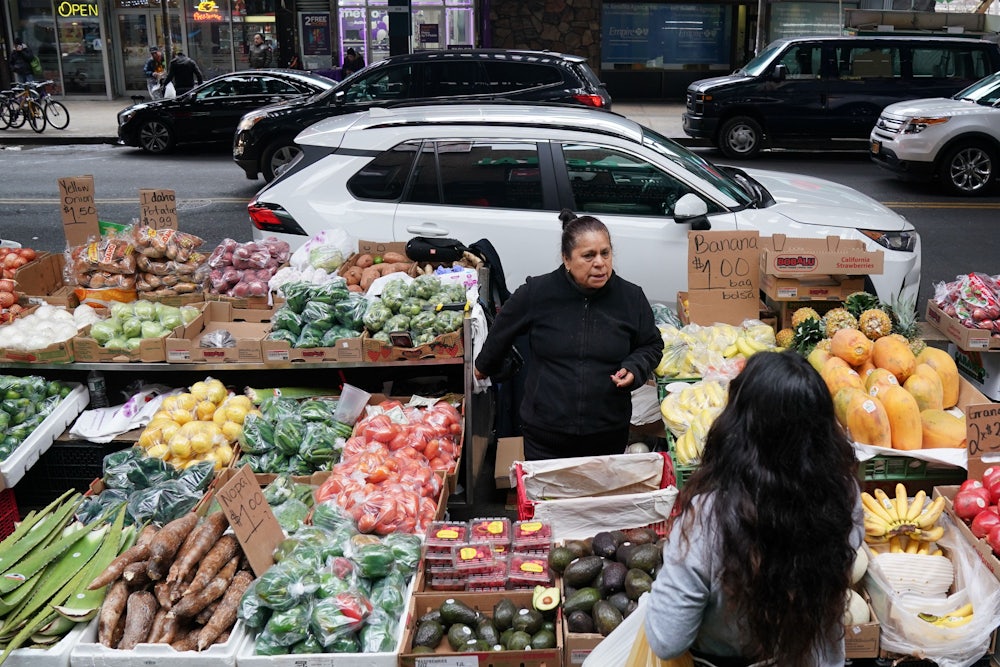 A woman sells produce on a street in the Queens in November of 2019.