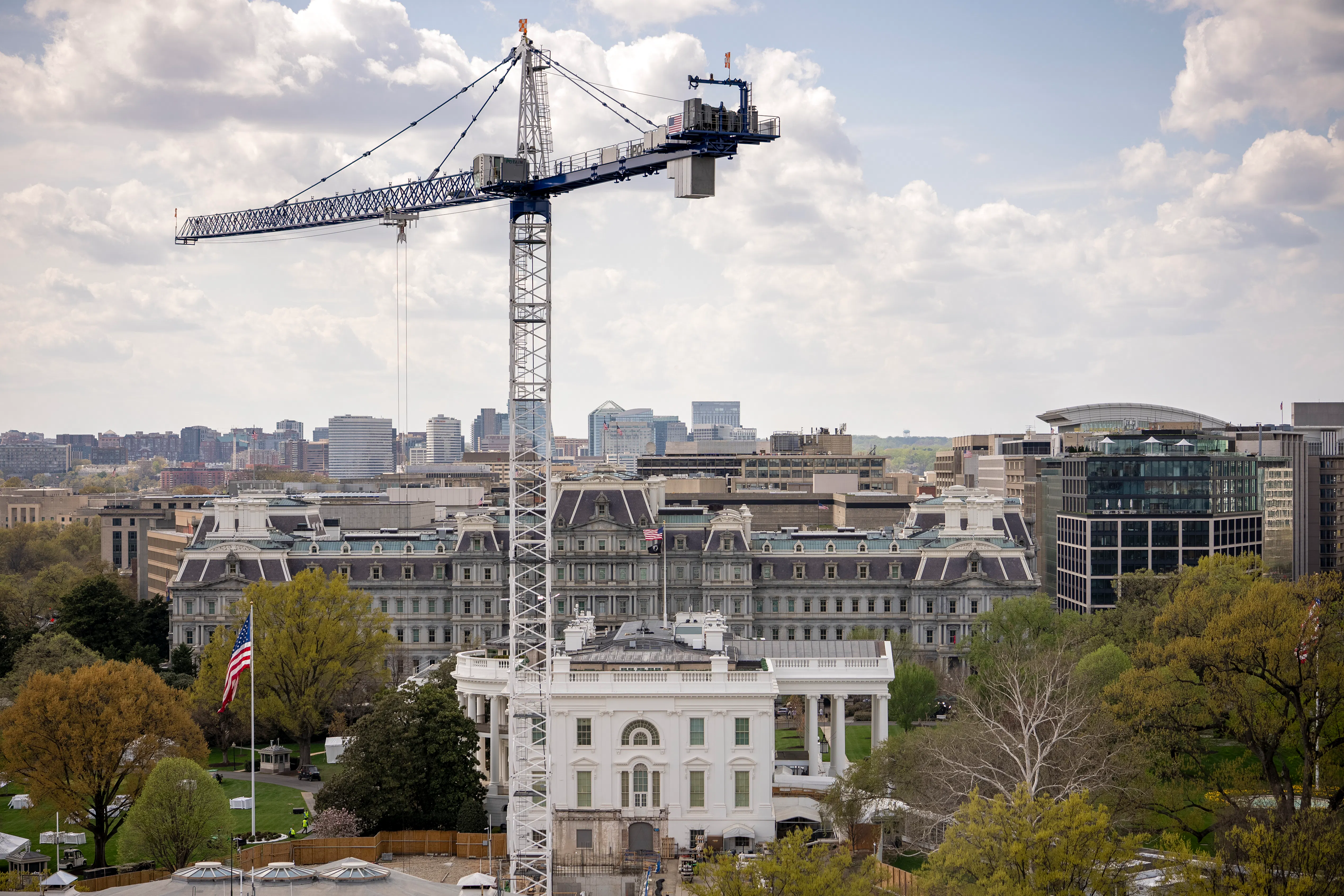 A crane stands next to the White House
