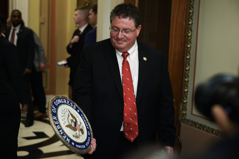 Representative Randy Fine holds a congressional seal while in the Capitol.