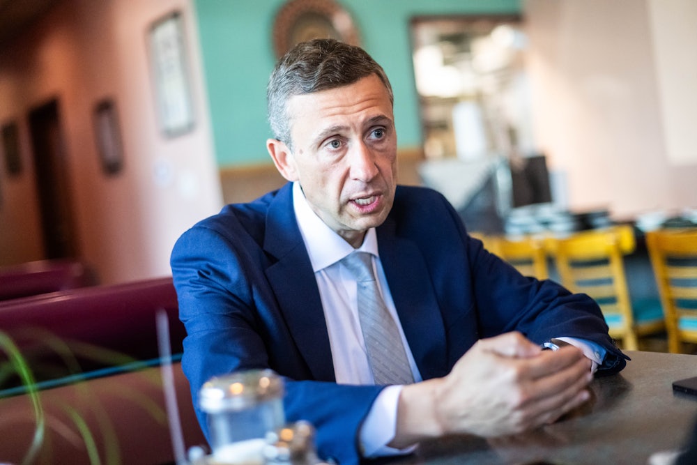 DNC Chair Ken Martin speaks while seated at a table.