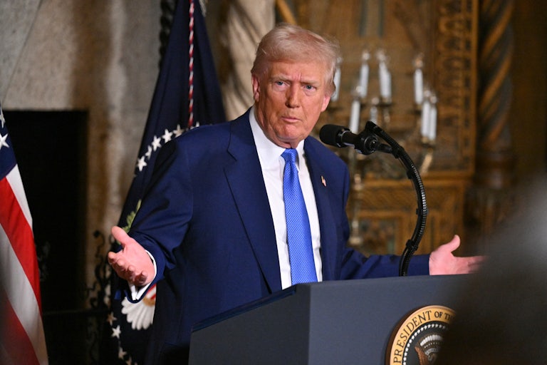 Donald Trump makes a shrugging gestures during a press conference at Mar-a-Lago