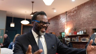 Chicago mayoral candidate Brandon Johnson smiles and holds his arms out