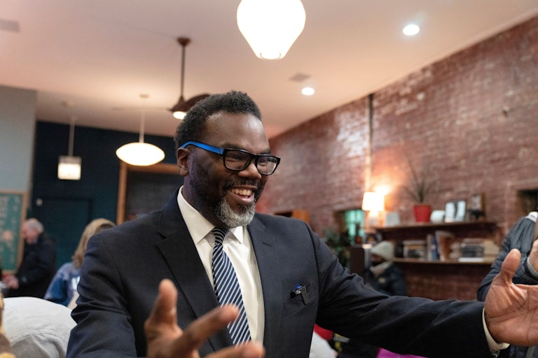 Chicago mayoral candidate Brandon Johnson smiles and holds his arms out