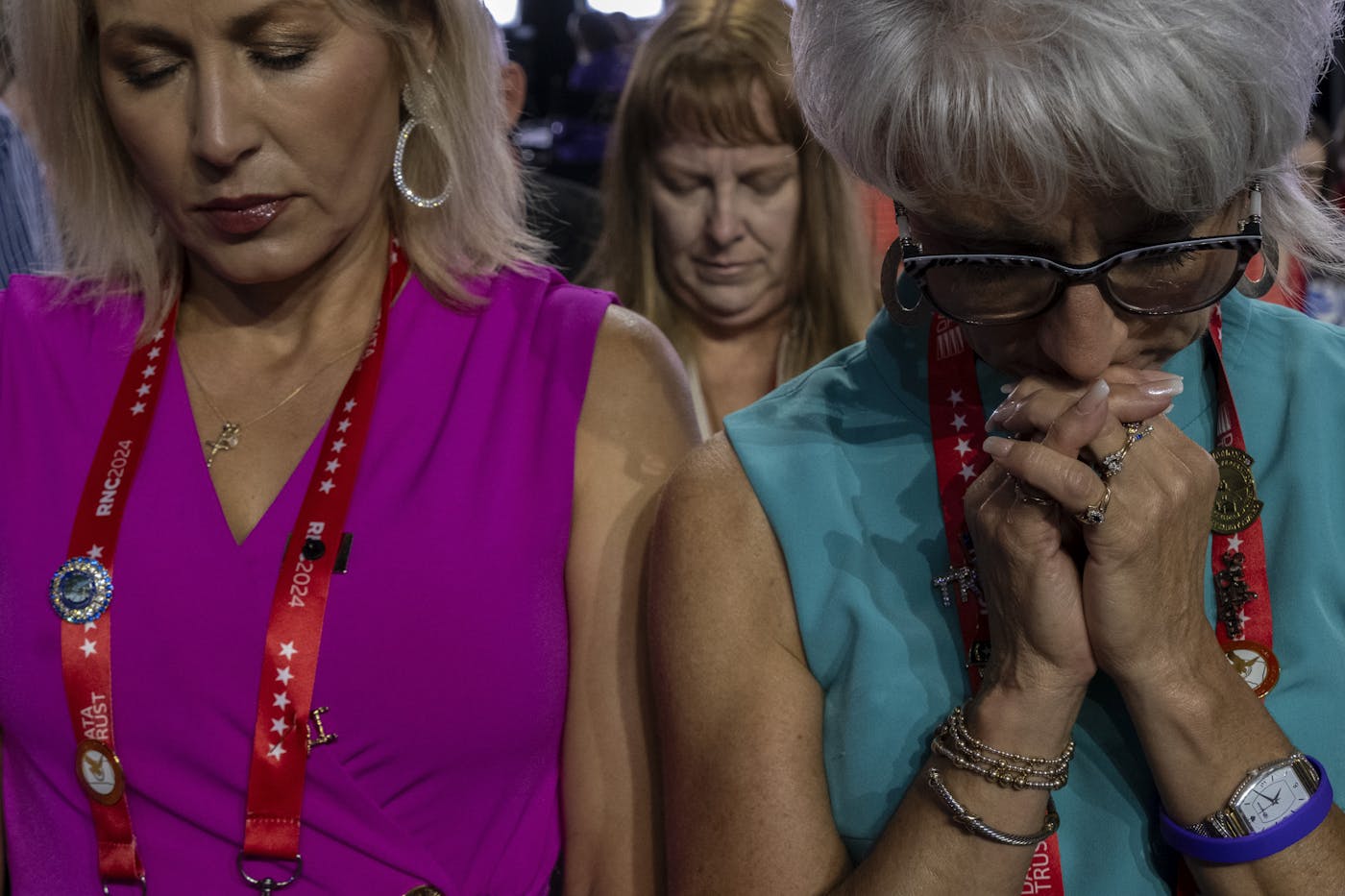 photograph of women praying while listenting to Donald Trump at the Republican National Convention 2024