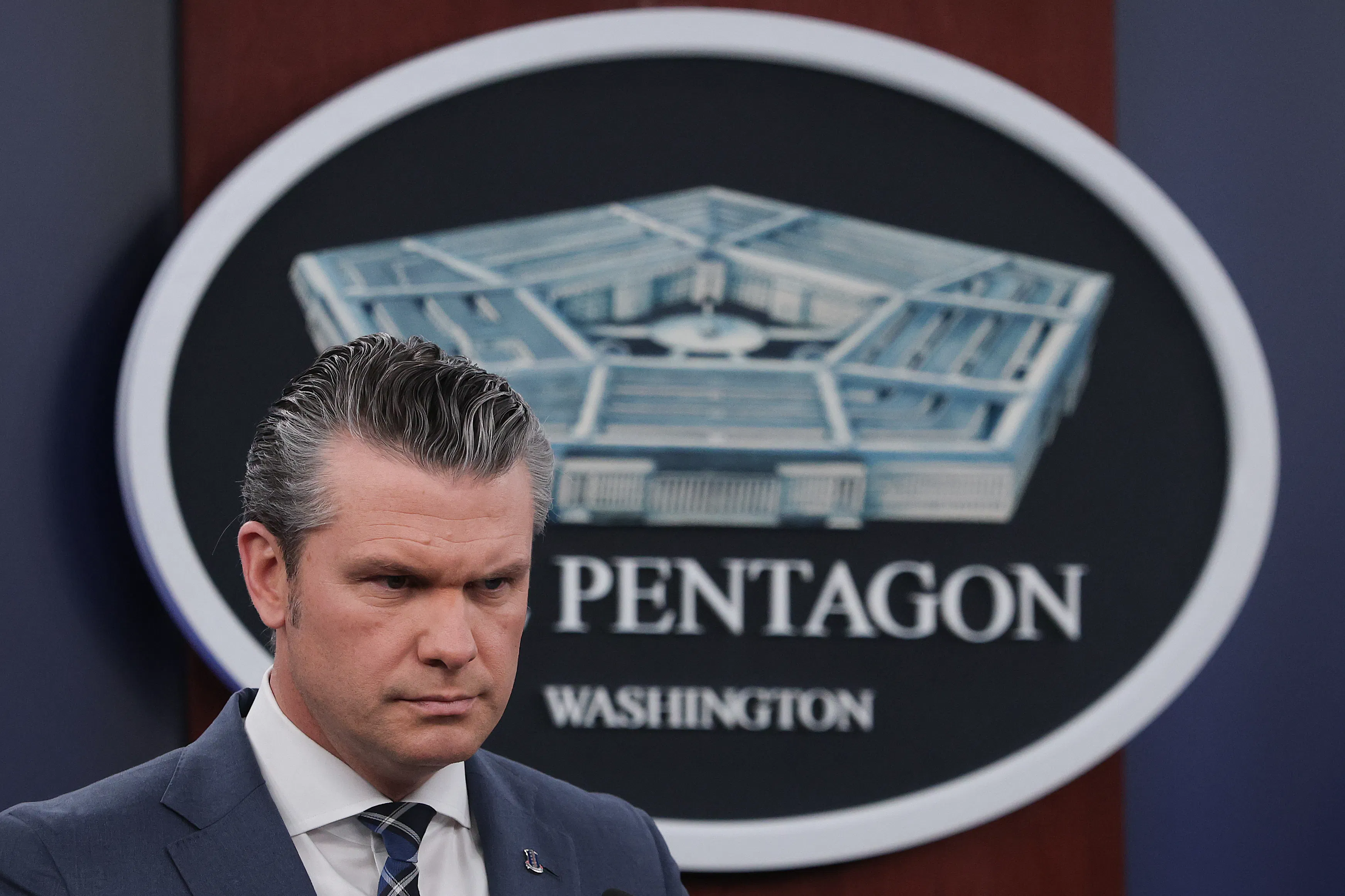 Defense Secretary Pete Hegseth frowns during a press conference