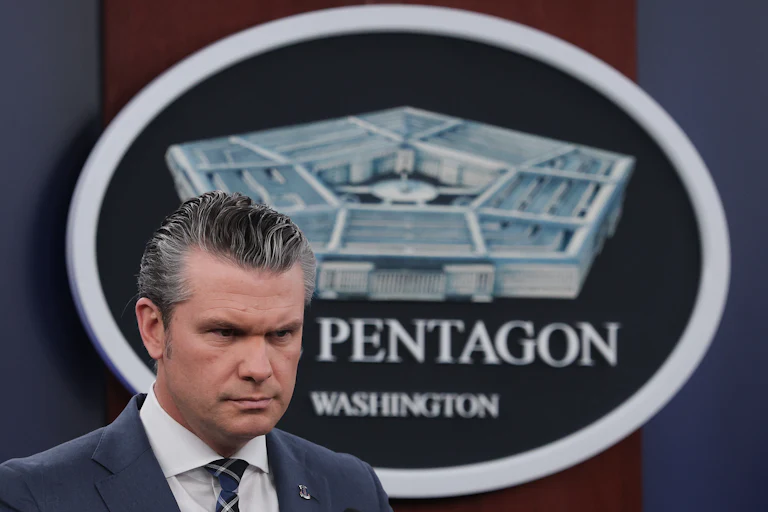 Defense Secretary Pete Hegseth frowns during a press conference