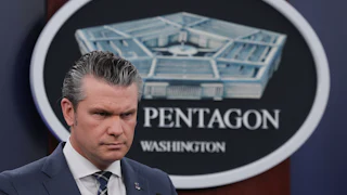 Defense Secretary Pete Hegseth frowns during a press conference