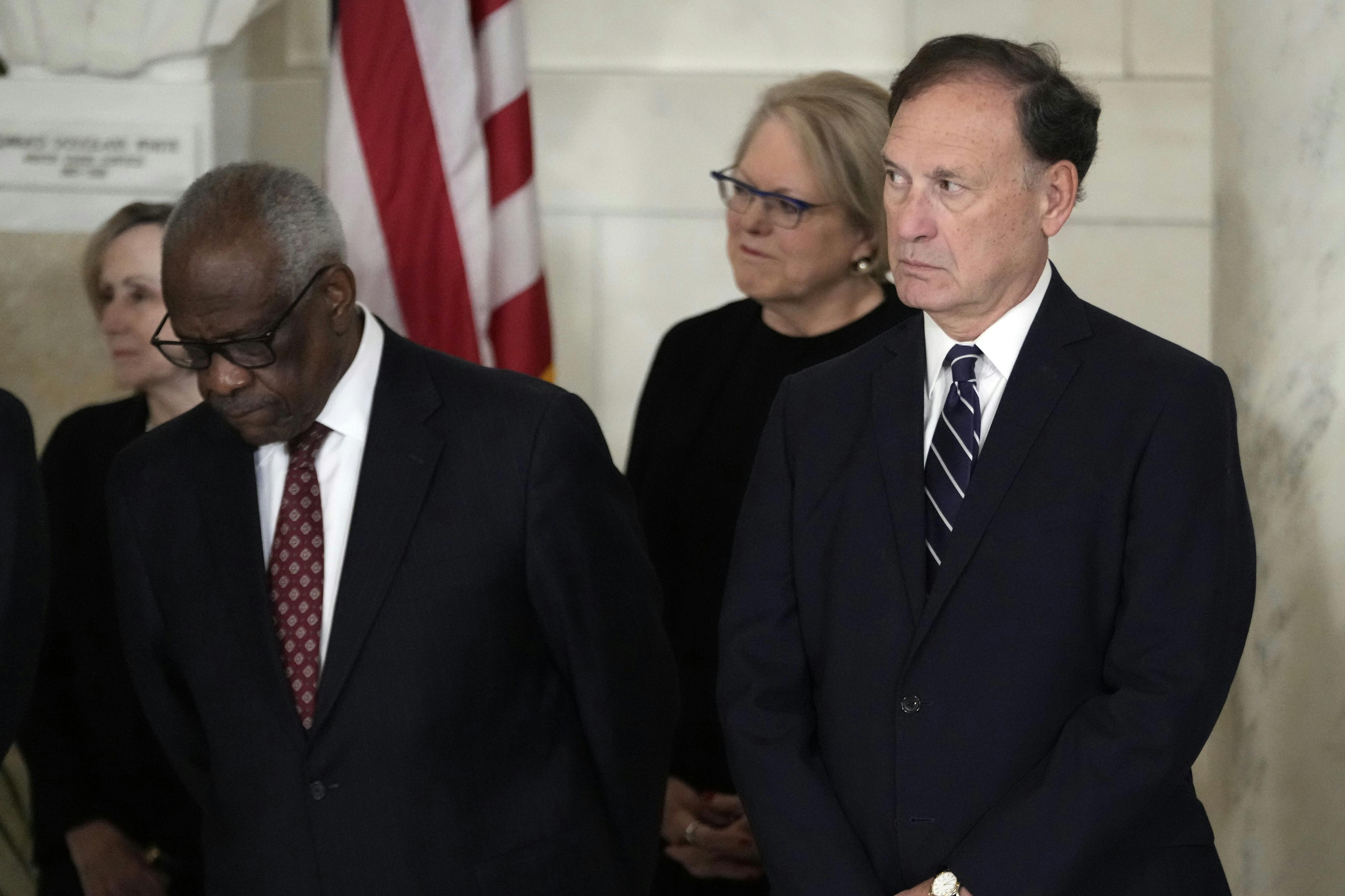 Justices Alito and Thomas stand, side by side.