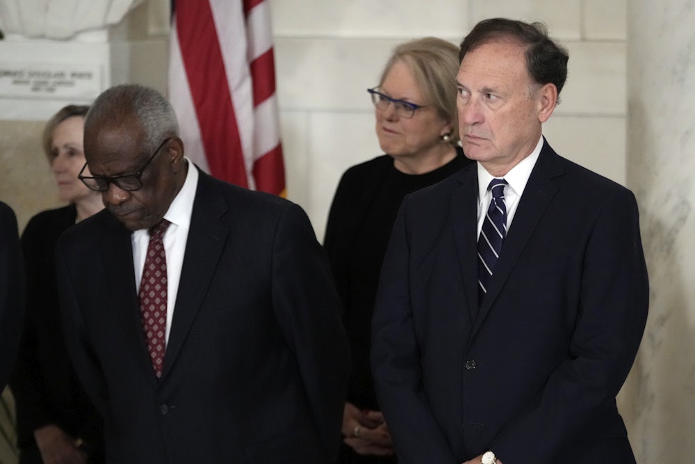 Justices Alito and Thomas stand, side by side.