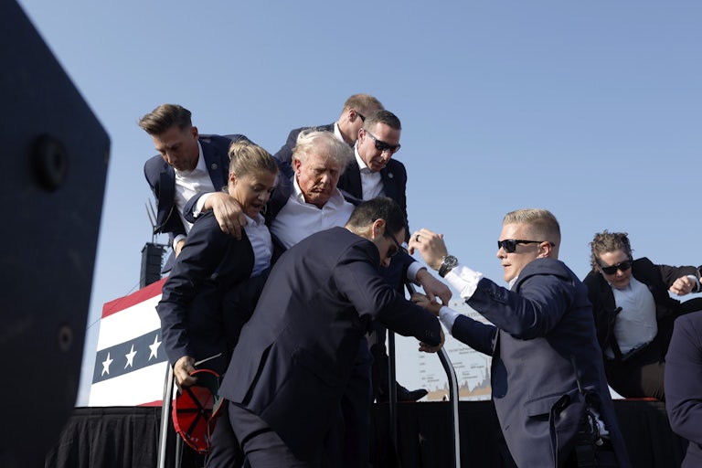Secret Service agents rush Donald Trump offstage after a shooting at his rally in Butler, Pennsylvania