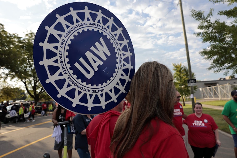 A United Auto Workers supporter holds a sign during a Labor Day parade in Detroit, Michigan.