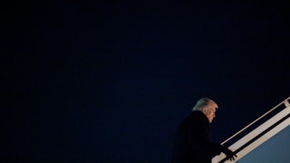 Donald Trump walks up the stairs to board Air Force One
